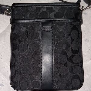 Black Coach Purse With A Crossbody Adjustable Strap.